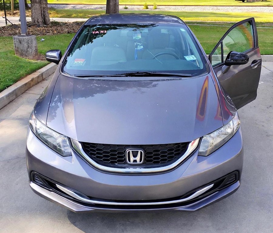The front of the 2014 Honda Civic LX, taxi decal on the windscreen