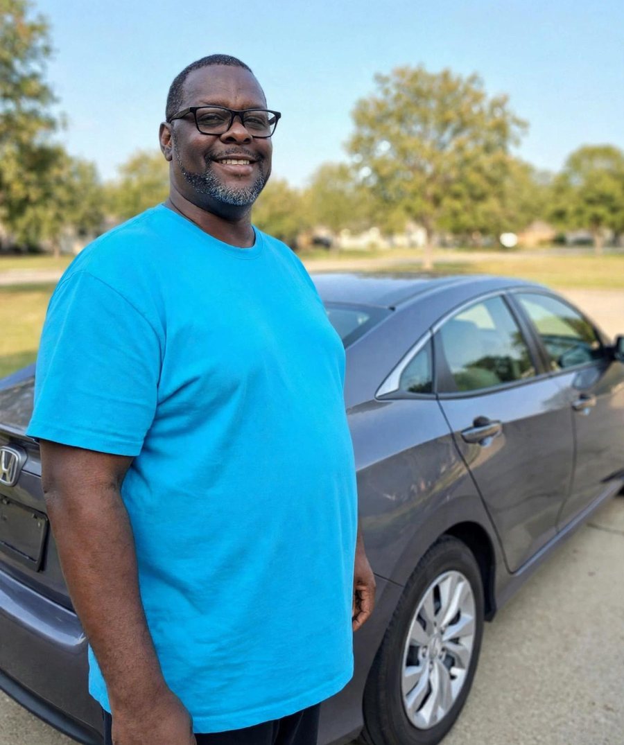 Cedric Surry, the owner, standing beside his 2014 Honda Civic LX
